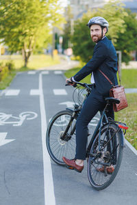 Man riding bicycle on road