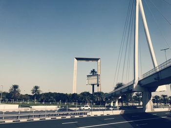 Bridge over road against clear sky