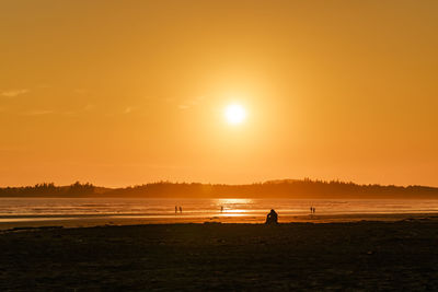 Scenic view of beach against sky during sunset