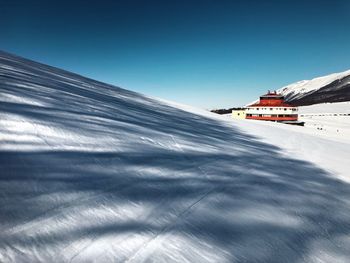 Snowcapped mountain against clear blue sky