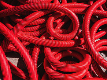 Full frame shot of red plastic pipes