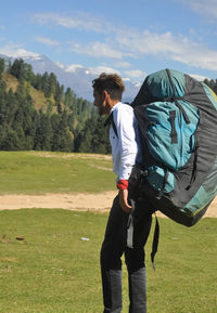 A male tourist with parachute backpack in the mountain 