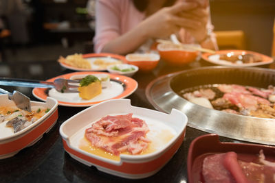 Midsection of woman eating food at restaurant