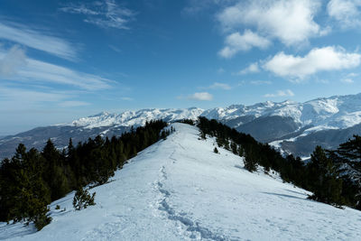 Scenic view of snowcapped mountains against sky