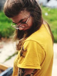 Close-up of woman with lizard outdoors