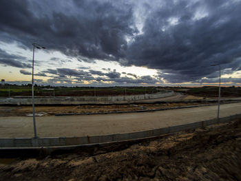 Storm clouds over landscape against sky