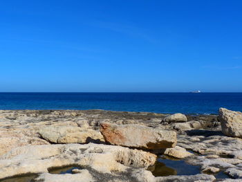 Scenic view of sea against clear blue sky