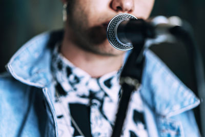 Midsection of young man singing