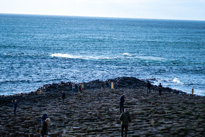 People on beach against sky