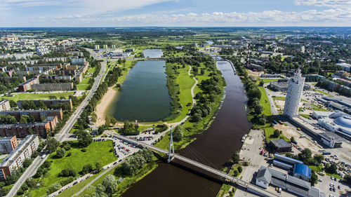 High angle view of cityscape by sea against sky