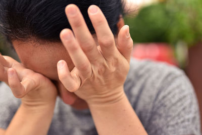 Close-up of woman rubbing eyes