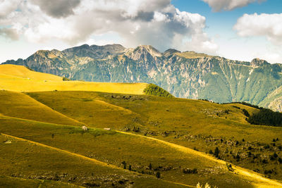 Scenic view of landscape against mountains and sky