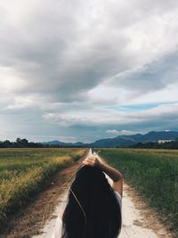 View of person riding horse on field against sky