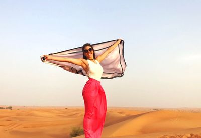 Woman standing in a desert