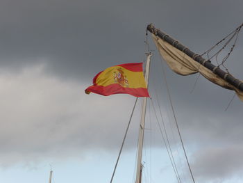 Low angle view of flag on pole against sky