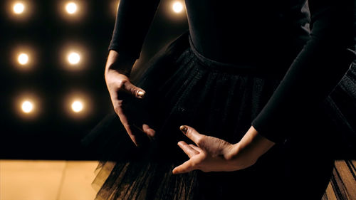 Midsection of female ballet dancer performing at stage