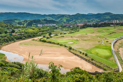 Aerial view to the river, golf field and city on a beautiful summer day