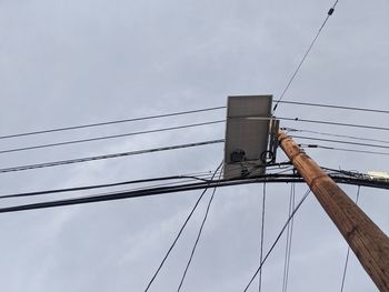 Low angle view of electricity pylon against sky