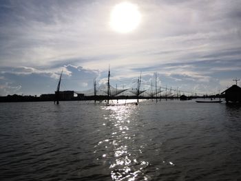 Bridge over sea against sky during sunset