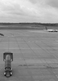 Airplane on airport runway against sky