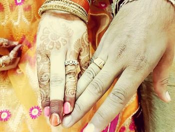 Close-up of couple holding hands