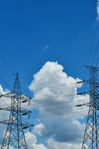Low angle view of electricity pylon against sky