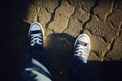 Low section of man standing on tiled floor