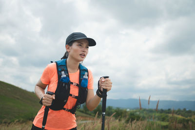 Portrait of young man standing against sky