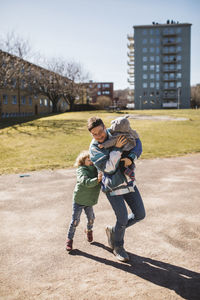 Mother playing with children outside