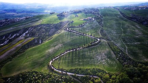 High angle view of road amidst grassy landscape