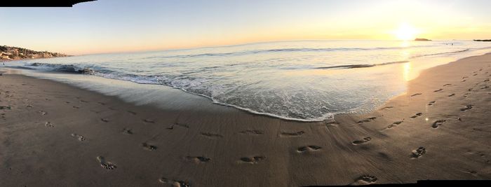 Scenic view of beach against sky during sunset