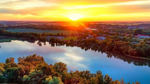 Scenic view of lake against sky during sunset