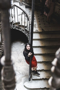 Portrait of beautiful woman sitting on steps