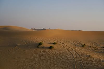 Scenic view of desert against sky during sunset