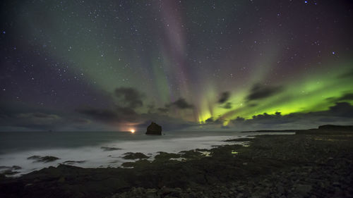 Scenic view of sea against sky at night