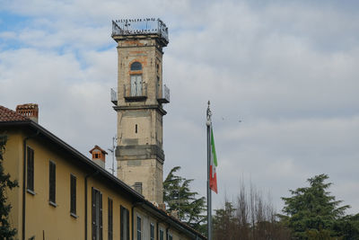 Low angle view of flags on building against sky