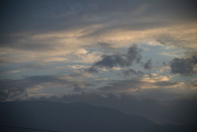 Low angle view of silhouette mountain against dramatic sky