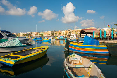Traditional colorful luzzu fishing boats  anchoring in marsaxlokk harbor, malta