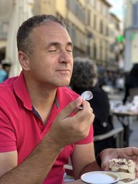 Side view of man tasting tiramisu 