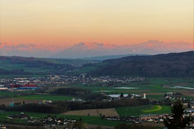 Scenic view of landscape against sky at sunset
