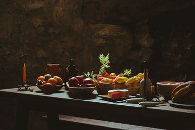 Various fruits on table against wall