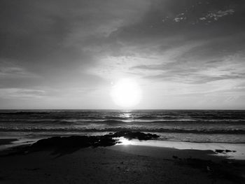 Scenic view of beach against sky during sunset