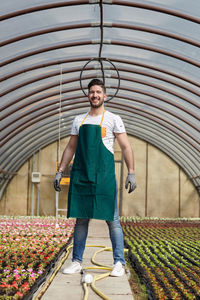 Full length of man standing in greenhouse