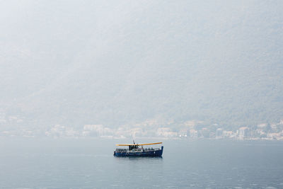 Ship sailing on sea against sky