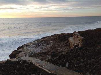 Scenic view of beach against sky during sunset