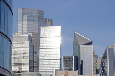 Low angle view of modern buildings against clear sky