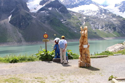 Rear view of men standing on mountain road