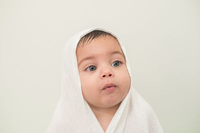 Portrait of cute boy against white background