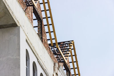 Low angle view of construction site against clear sky