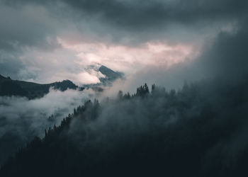 Cloudscape over mountains in forest